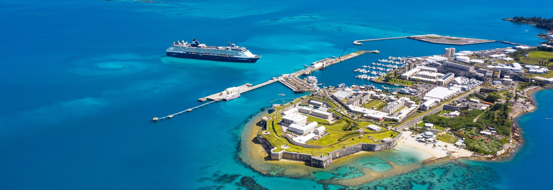 Aerial of a cruise ship about to dock at an island