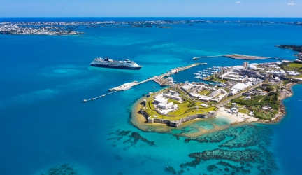 Aerial of a cruise ship about to dock at an island