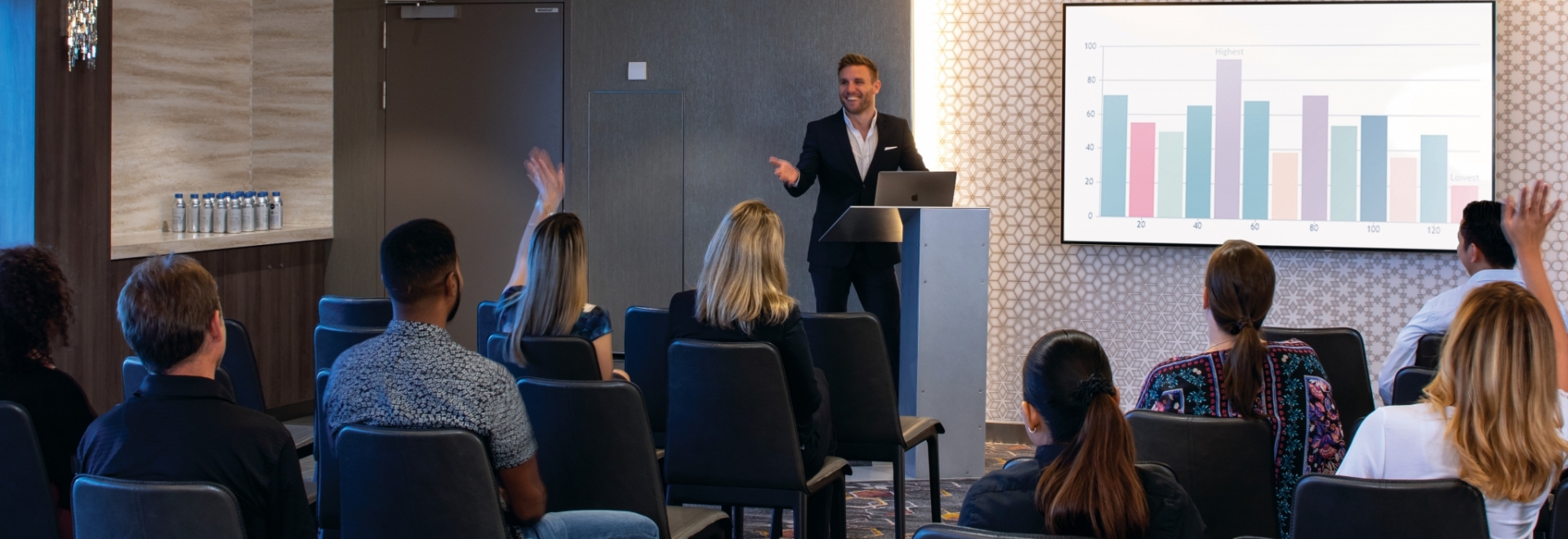 A man leading a training session in a conference room.