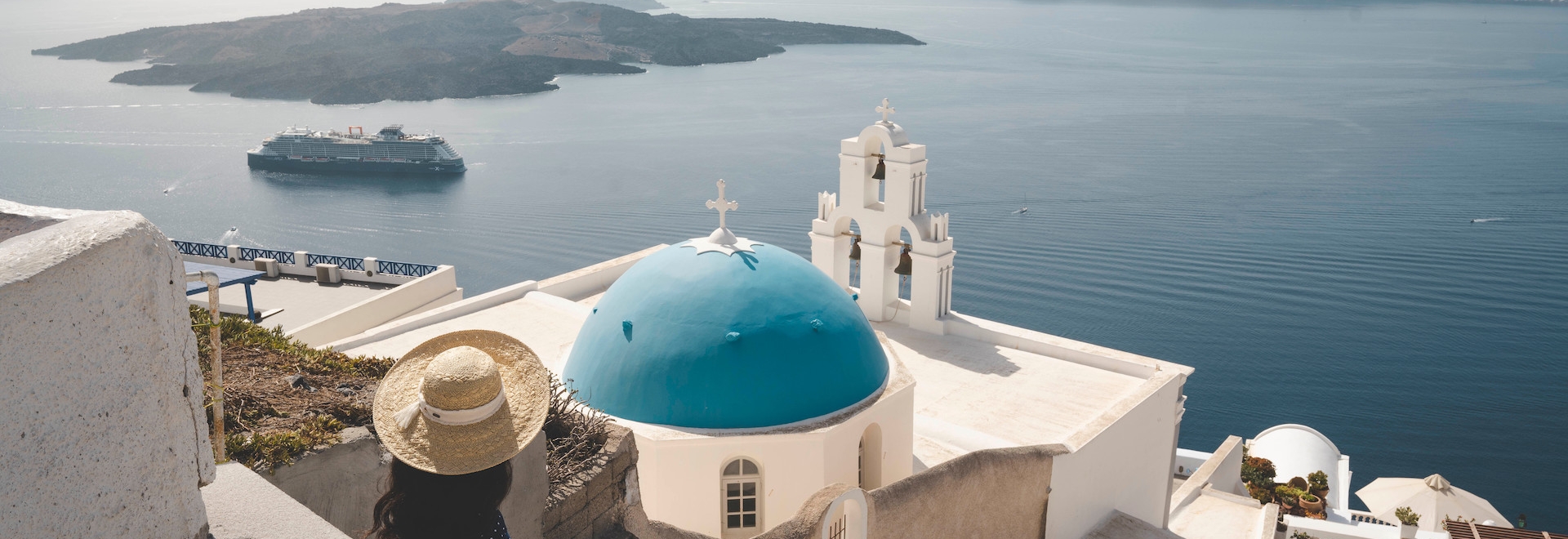 A woman watching the ocean in Santorini