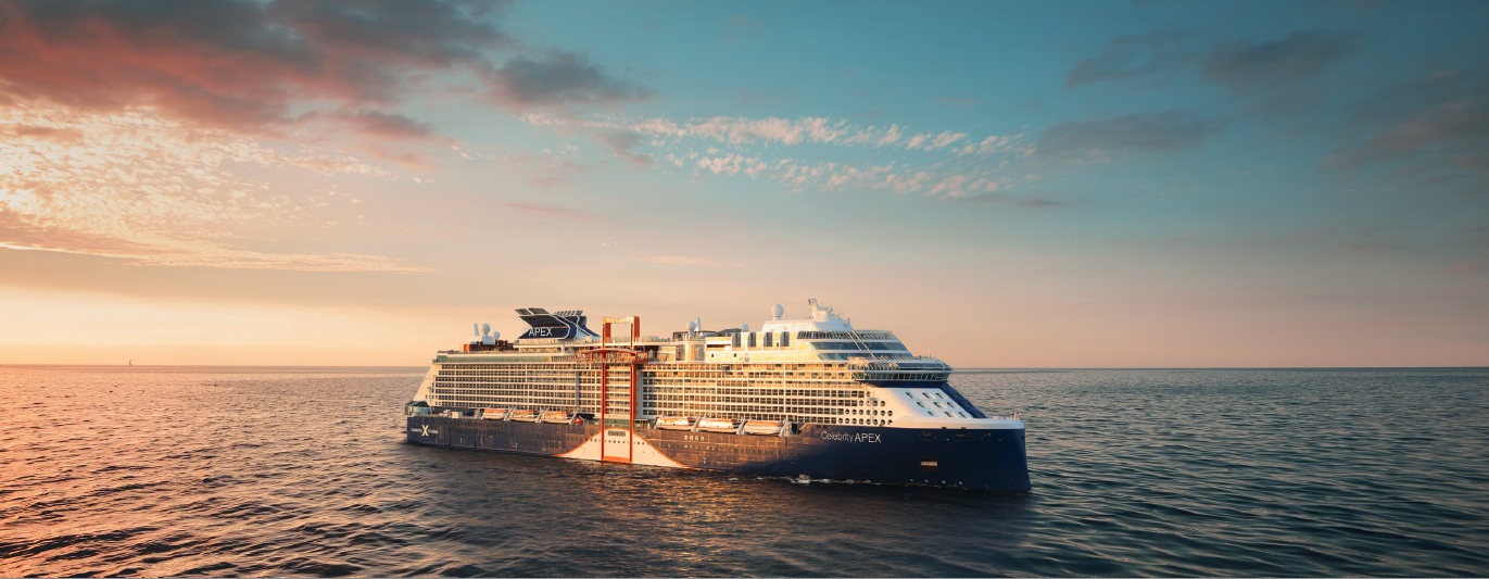A large cruise ship sailing at sunset